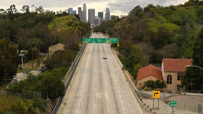 Light traffic moves along the 110 Harbor Freeway toward downtown Los Angeles, March 20, 2020.