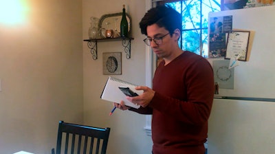 Neuroscientist Michael Wells works on the COVID-19 Pandemic Shareable Scientist Response Database in his home in Cambridge, Mass., March 25, 2020.