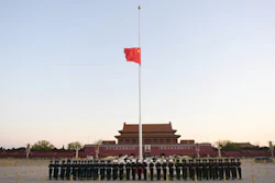 Honor guard in formation as a Chinese national flag flies at half-staff at Tiananmen Square, Beijing, April 4, 2020.