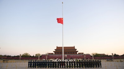 Honor guard in formation as a Chinese national flag flies at half-staff at Tiananmen Square, Beijing, April 4, 2020.