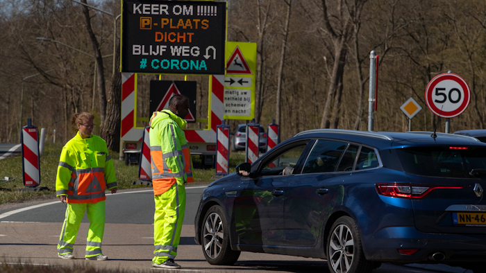 Regulators turn back non-essential traffic on a road leading to the beach resort of Zandvoort, Netherlands, April 4, 2020.