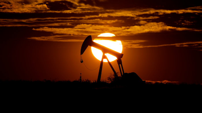 The sun sets behind an idle pump jack near Karnes City, Texas, April 8, 2020.