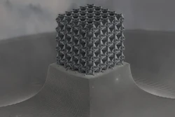 Closed-cell, plate-based nanolattice structure with wall thicknesses of about 160 nanometers.