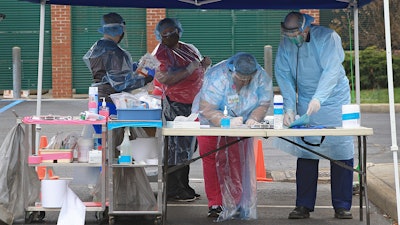 Doctors and nurses at a Mobile Health Unit at Robert C. Byrd Clinic on the campus of the West Virginia School of Osteopathic Medicine, Lewisburg, W.Va., March 24, 2020.