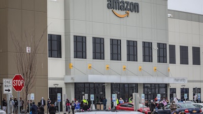 Workers at Amazon's fulfillment center in Staten Island, N.Y., gather outside to protest work conditions, March 30, 2020.