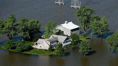 Flood water surrounds a home outside of West Alton, Mo., June 5, 2019.