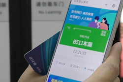 A passenger holds up a green pass on their phone on a subway train in Wuhan, China, April 1, 2020.