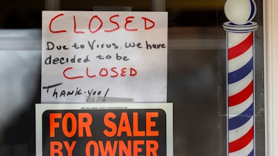 Signs in the window of Images On Mack, Grosse Pointe Woods, Mich., April 2, 2020.
