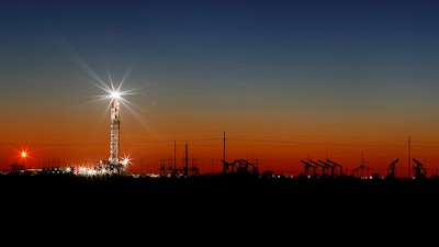 Oil rig lights on the outskirts of Midland, Texas, April 2, 2020.