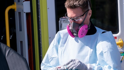 A paramedic cleans ambulance equipment after transporting a patient to Verdun Hospital in Montreal, April 6, 2020.