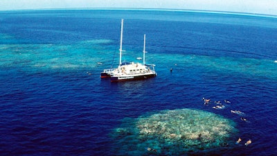 Tourists snorkel around Upolu Cay on the Great Barrier Reef near Cairns, Australia, Dec. 1999.