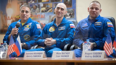 U.S. astronaut Chris Cassidy, left, Russian cosmonauts Anatoly Ivanishin, center, and Ivan Vagner attend a news conference at the Baikonur Cosmodrome, Kazakhstan, April 8, 2020.