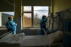 Medical staff check a ventilator at the Koranyi National Institute of Pulmonology, Budapest, March 24, 2020.