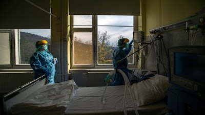 Medical staff check a ventilator at the Koranyi National Institute of Pulmonology, Budapest, March 24, 2020.