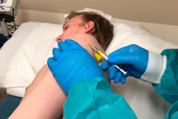 A participant in a COVID-19 vaccine trial receives an injection in Kansas City, Mo., April 8, 2020.