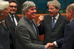 Eurogroup President Mario Centeno, center, shakes hands with German Finance Minister Olaf Scholz, Jan. 20, 2020.