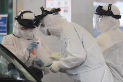 Medical staff at a drive-thru virus test facility in Goyang, South Korea, March 1, 2020.