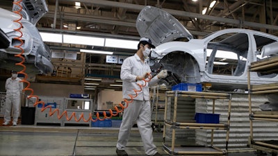 Workers at the Dongfeng Honda Automobile Co. factory in Wuhan, April 8, 2020.