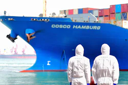 Workers in protective suits near a COSCO container ship docked at a port in Qingdao, China, March 31, 2020.