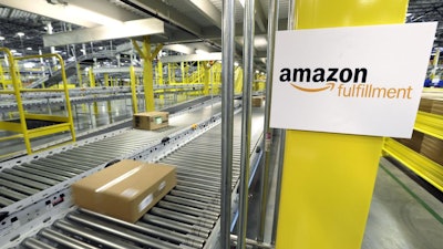 A package moves along a conveyer belt during a media tour of the Amazon fulfillment center in DuPont, Wash., Feb. 13, 2015.