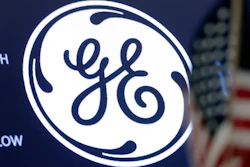 The General Electric logo appears above a trading post on the floor of the New York Stock Exchange.