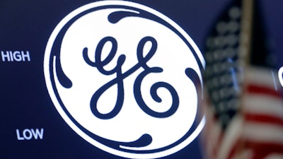 The General Electric logo appears above a trading post on the floor of the New York Stock Exchange.