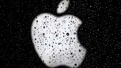 In this Dec. 26, 2018, file photo an Apple logo is seen in raindrops on a window outside an Apple Store at the Country Club Plaza shopping district in Kansas City, Mo. Apple is reducing the size of its workforce assigned to driverless car technology as the company reorganizes amid weakening sales of iPhones, its biggest moneymaker. The company acknowledged the cutbacks in a Thursday, Jan. 24, 2019, statement, without specifying the number of jobs affected. CNBC reported that more than 200 employees were dismissed from Apple’s self-driving car division, known internally as “Project Titan.”