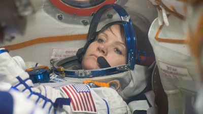 Anne McClain of NASA runs through procedures in the Soyuz MS-11 spacecraft during a vehicle fit check Nov. 20.