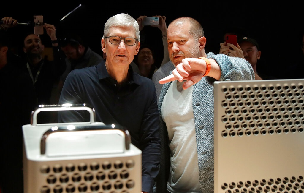 FILE - In this Monday, June 3, 2019 file photo, Apple CEO Tim Cook, left, and chief design officer Jonathan Ive look at the Mac Pro in the display room at the Apple Worldwide Developers Conference in San Jose, Calif. On Thursday, June 27, 2019, Apple said that Ive, chief design officer, will be leaving after more than two decades at the company to start his own firm.