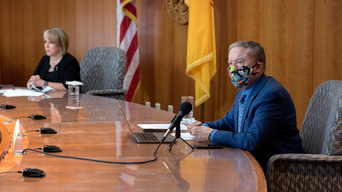 Health and Human Services Secretary Dr. David Scrase gives an update on the COVID-19 outbreak in New Mexico alongside Gov. Michelle Lujan Grisham, April 15, 2020.