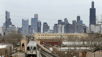 A CTA train travels west away from downtown Chicago, March 23, 2017.