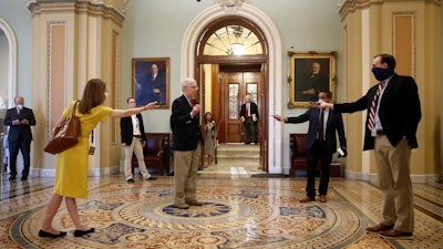 Senate Majority Leader Mitch McConnell of Ky., center, speaks with reporters outside the Senate chamber on Capitol Hill.