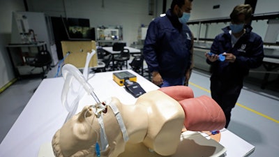 Prototype low-cost ventilator calibrated by La Sabana University engineers Julian Echeverry, left, and Andres Ramirez, Bogota, April 14, 2020.