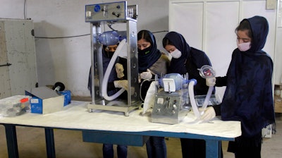 A group of young girls works on a cheap ventilator using Toyota car parts, Herat, Afghanistan, April 8, 2020.