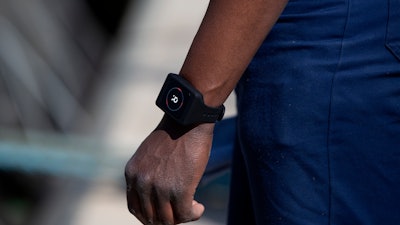 Deckhand Gerard Bakulikira wears a Romware COVID Radius digital bracelet at the Port of Antwerp, Belgium, April 22, 2020.