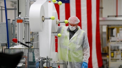 Bill Merkle works on making protective masks in Warren, Mich., April 23, 2020.