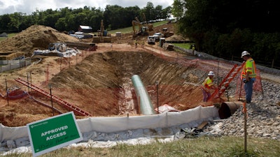 Construction crews bore beneath U.S. 221 in Roanoke County, Va., during construction of the Mountain Valley Pipeline, June 22, 2018.