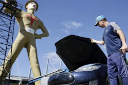 Andrew Nelson lifts the hood of his Tesla Model S in front of the Golden Driller as it gets a Tesla facelift, May 19, 2020.