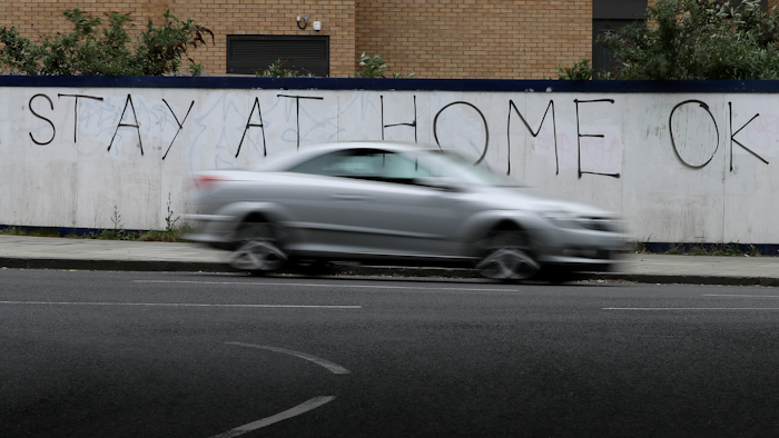 A car passes graffiti during the lockdown in London, April 13, 2020.