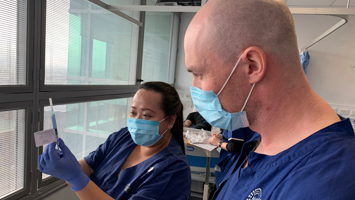 Technicians prepare for a clinical trial of a vaccine in Melbourne, Australia, May 26, 2020.