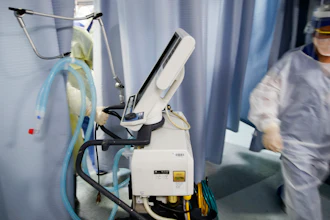 A nurse pulls a ventilator into an exam room at St. Joseph's Hospital in Yonkers, N.Y., April 20, 2020.