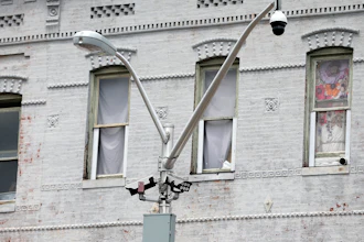 A surveillance camera, top right, and license plate scanners, center, at an intersection in West Baltimore, April 29, 2020.