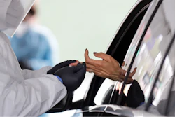 In this April 14, 2020 file photo, a woman holds her hand out to have blood collected for COVID-19 antibodies at a drive-thru site in Hempstead, N.Y. U.S. regulators on Monday, May 4 pulled back a decision that allowed scores of coronavirus blood tests to hit the market without first providing proof that they worked. The Food and Drug Administration said it took the action because some sellers have made false claims about the tests and their accuracy.
