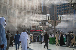 Water is sprayed over pilgrims outside the Grand Mosque in Mecca, Saudi Arabia, Sept. 15, 2015.