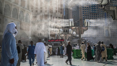 Water is sprayed over pilgrims outside the Grand Mosque in Mecca, Saudi Arabia, Sept. 15, 2015.