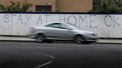 A car passes graffiti during the lockdown in London, April 13, 2020.