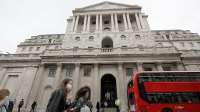 Pedestrians pass the Bank of England in London, March 11, 2020.