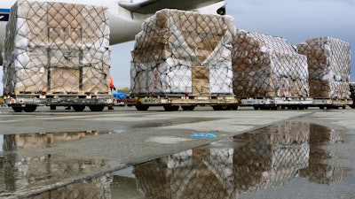 Pallets of medical personal protective equipment are unloaded from a Chinese cargo plane at Los Angeles International Airport, April 10, 2020.