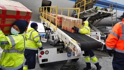 Ground crew unloads medical personal protective equipment from a China Southern Cargo plane, Los Angeles International Airport, April 10, 2020.