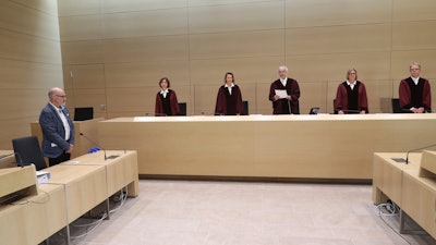 Presiding Judge at the Federal Court of Justice Stephan Seiters, center, announced the verdict in the trial between the Volkswagen company and the owner of a VW Diesel passenger car Herbert Gilbert, left, in Karlsruhe, Germany, May 25, 2020.